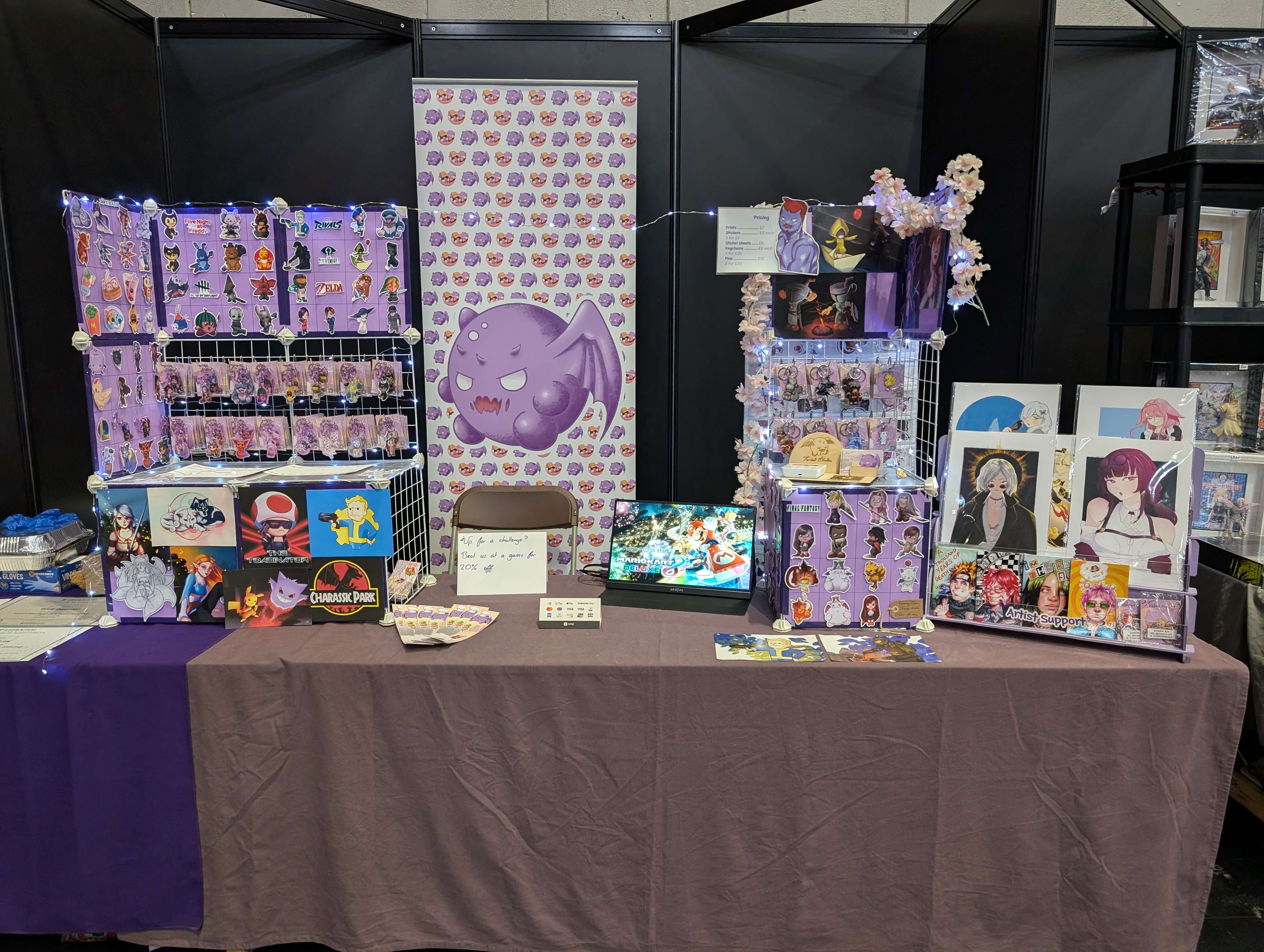 Taroball Studios convention booth with anime merchandise